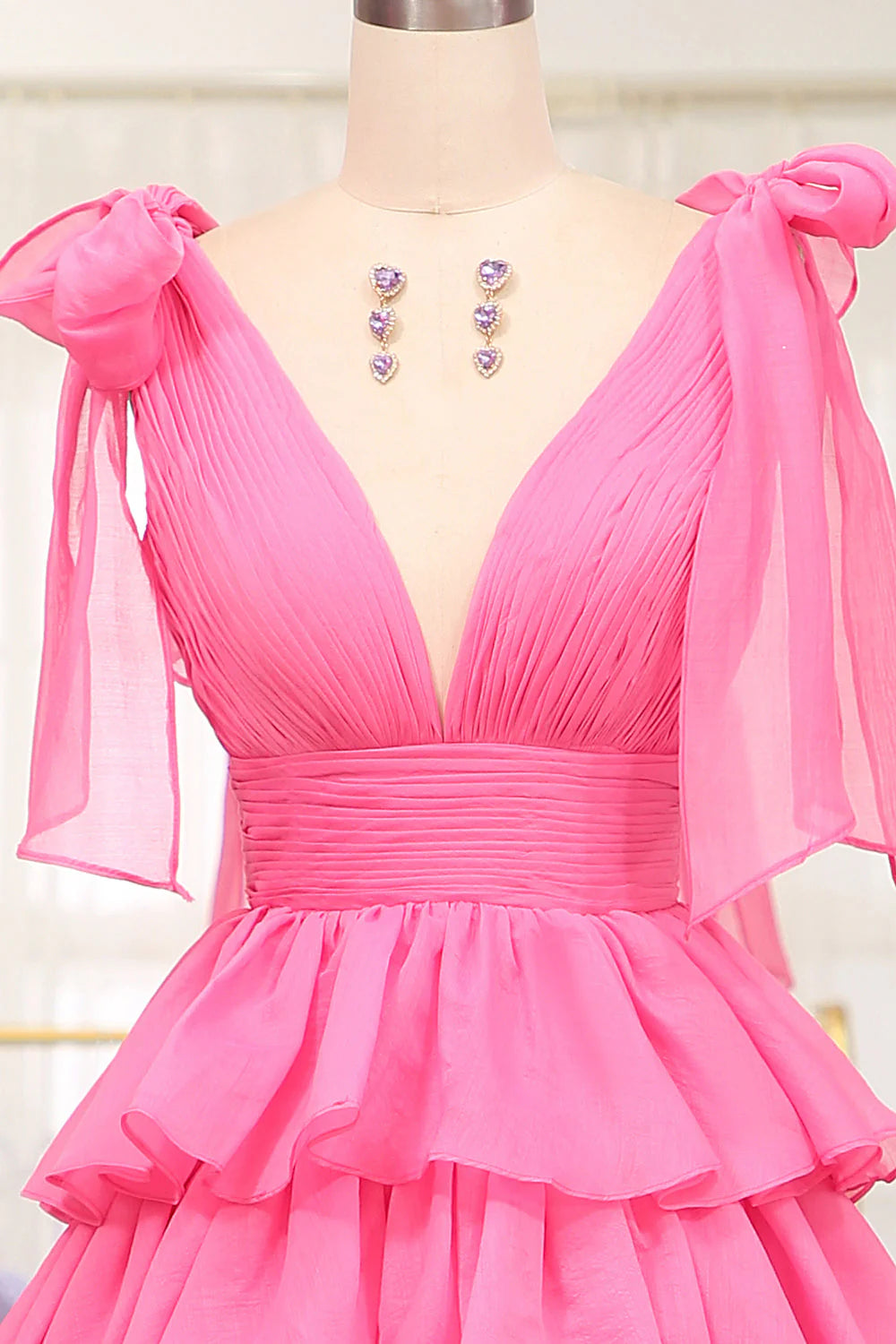 Close-up of the tiered skirt and V-neckline details of the long formal dress.
