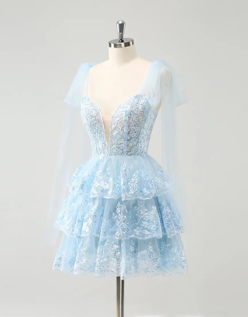 Close-up of the tiered tulle fabric and V-neckline of the dress.
