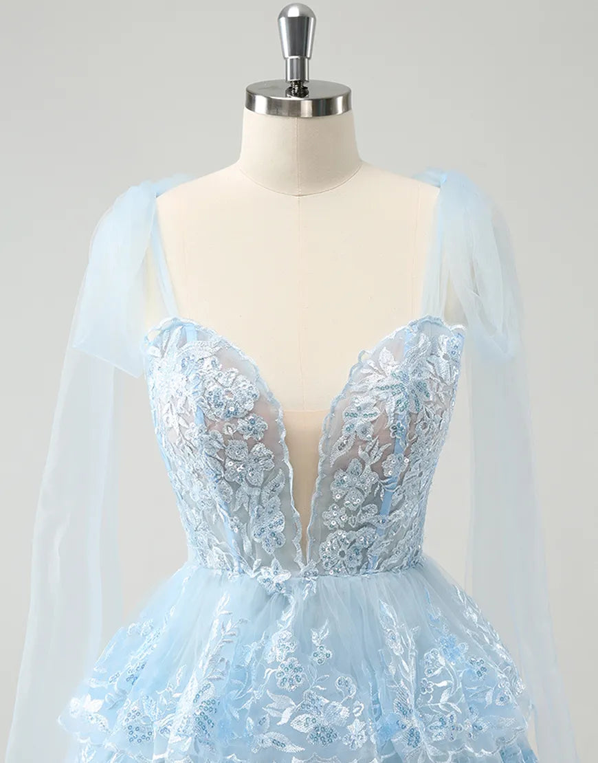 Model posing in the A-line tiered tulle homecoming dress.