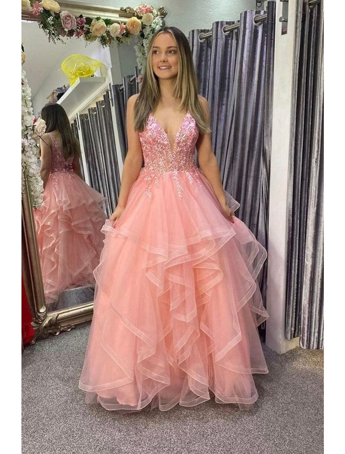 Front view of an elegant A-line V-neck tulle prom dress with appliques and pleats.