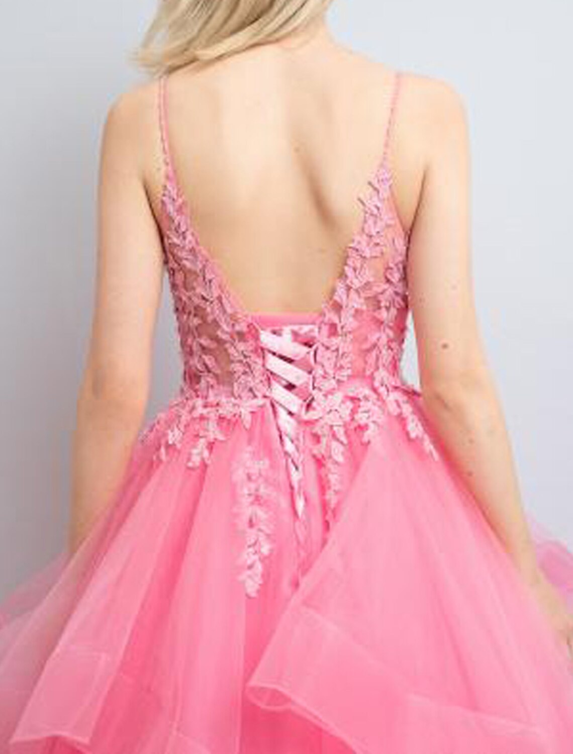 Back view of the A-line tulle prom dress, showcasing its backless design and flowing skirt.