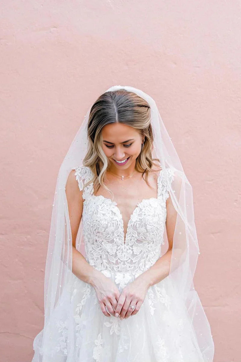 Close-up of tulle appliques on a V-neck A-line wedding dress.