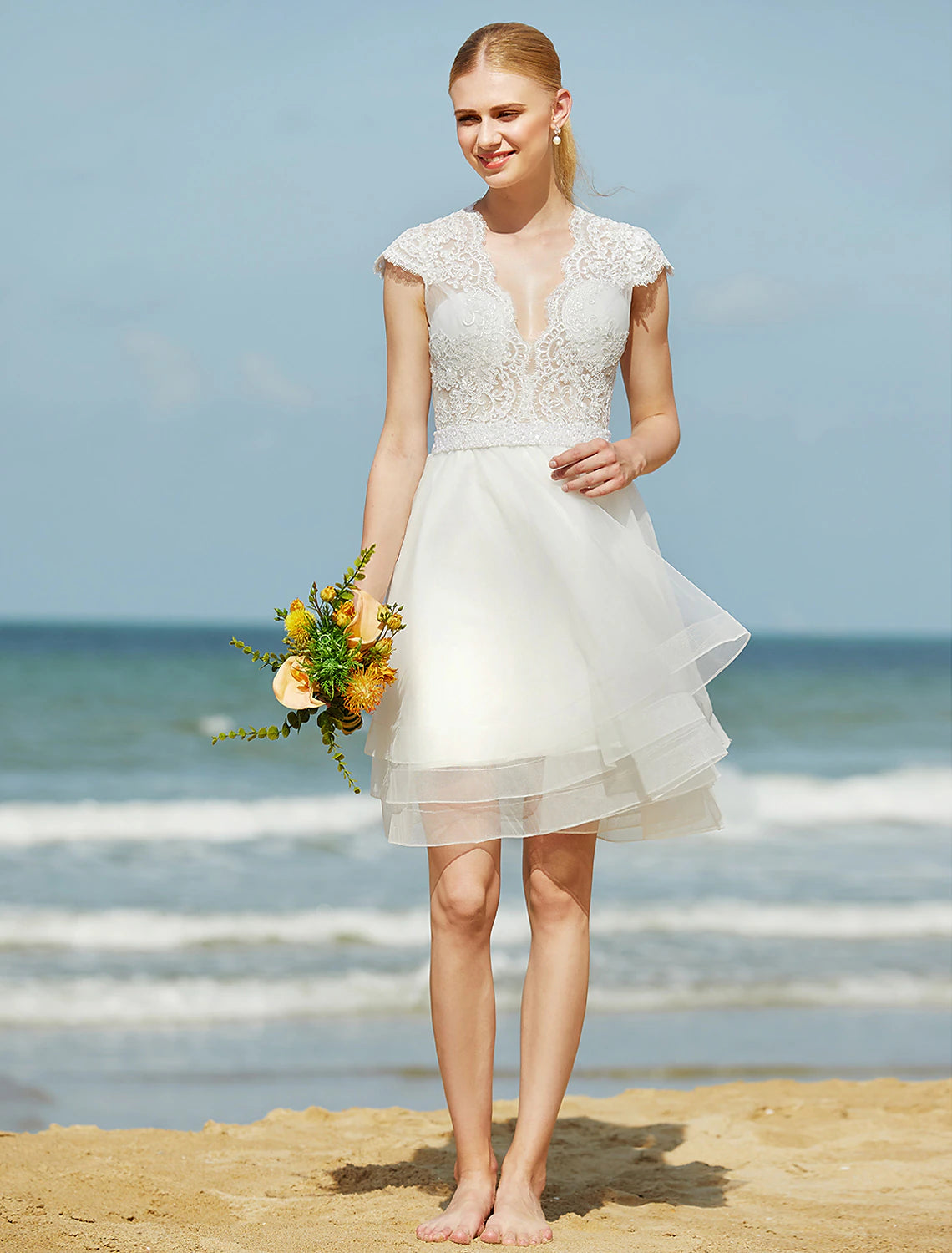 Model wearing the knee-length wedding dress, showcasing its flow.