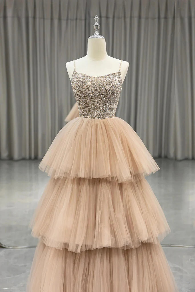 Model wearing an elegant A-line tulle beaded spaghetti strap long prom dress.
