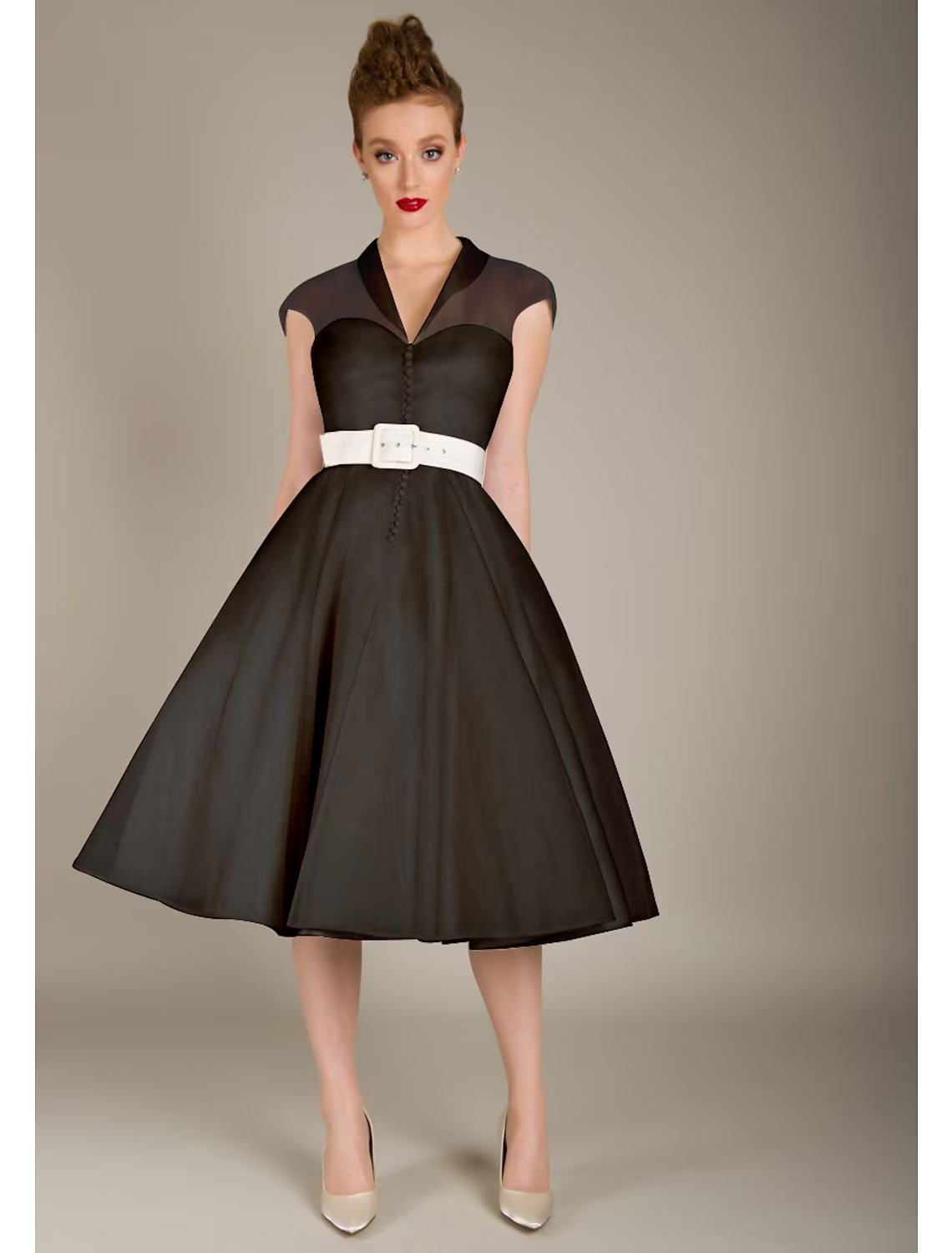 Side view of black knee-length sleeveless cocktail dress.