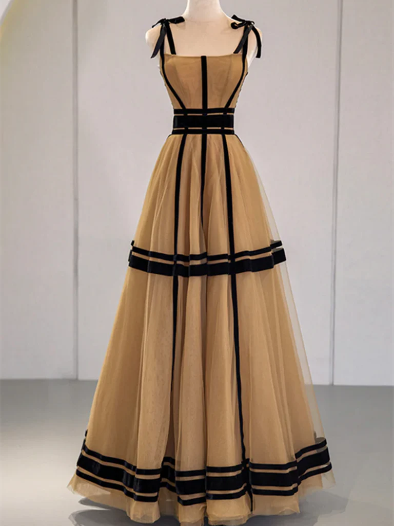 Woman wearing an elegant A-line V-neck tulle long prom dress in a light color.