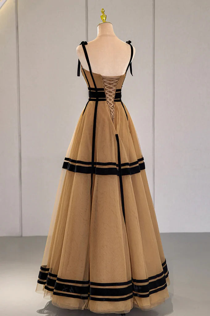 Woman posing in a flowing A-line V-neck tulle long prom dress, showcasing its silhouette.