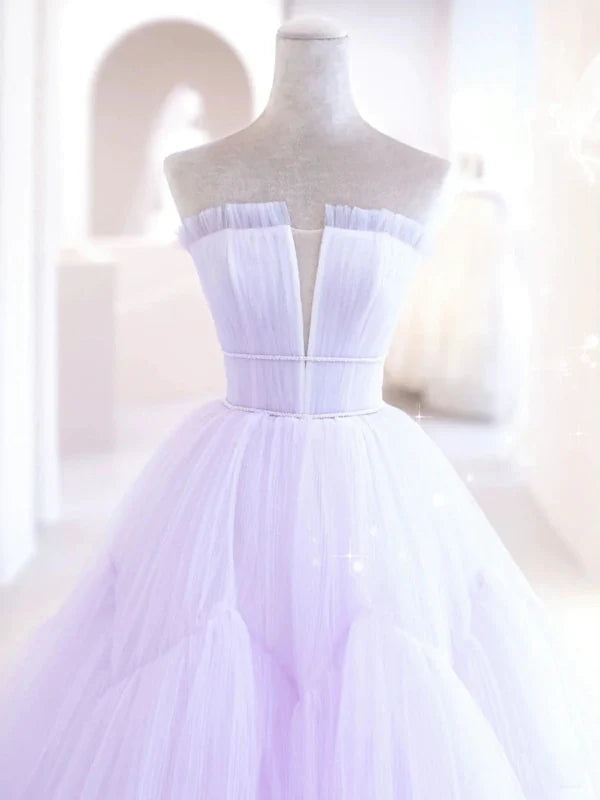 Side profile of a V-neck long formal tulle dress.