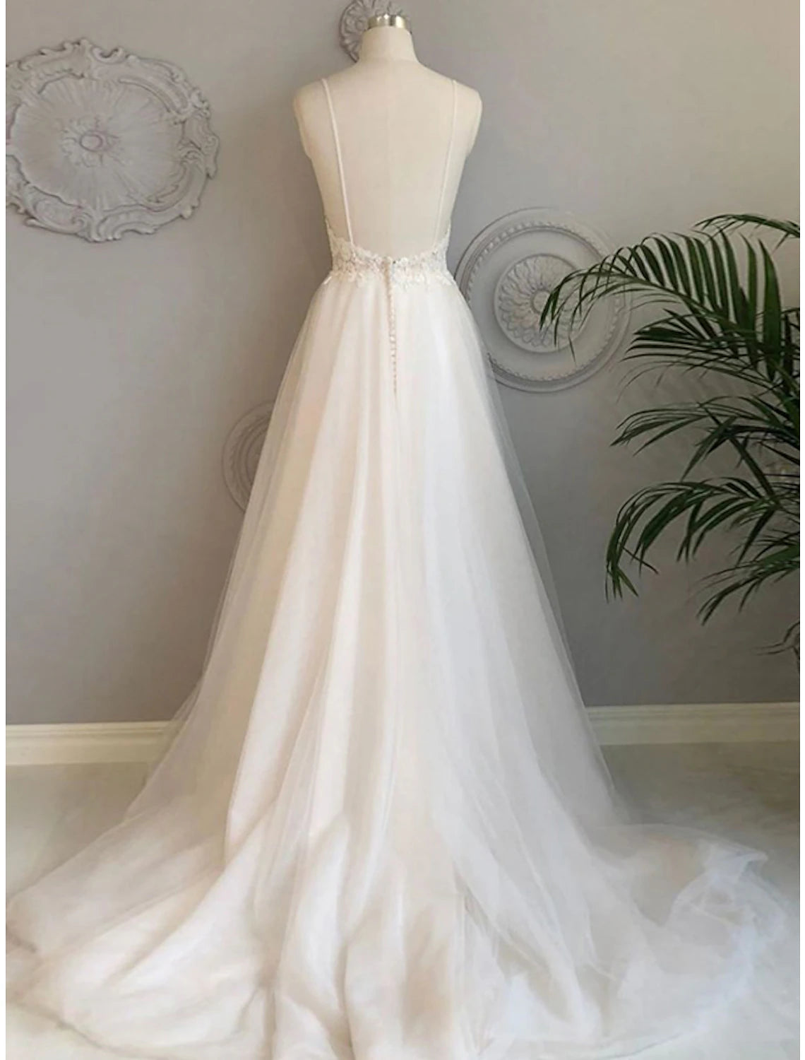 Back view of A-line V-neck tulle gown showing sweep train.