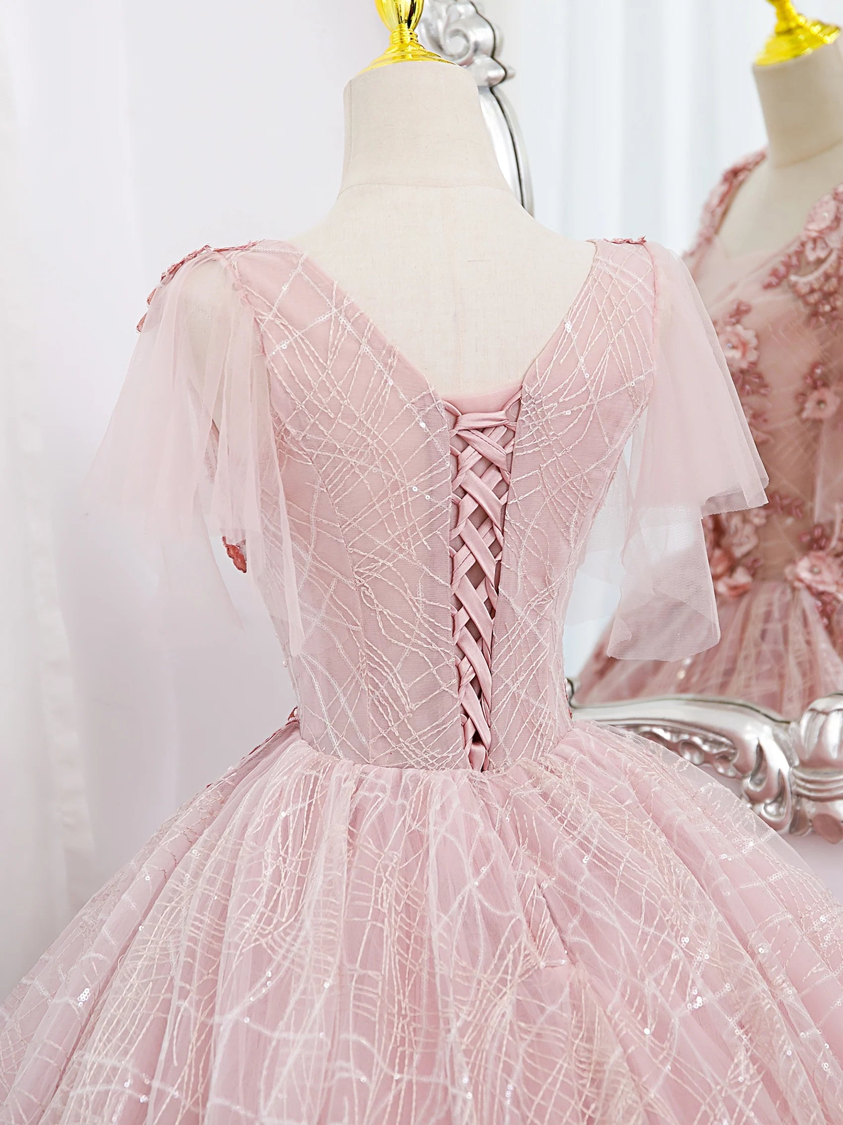 Close-up of the intricate lace applique on the bodice of the prom dress.