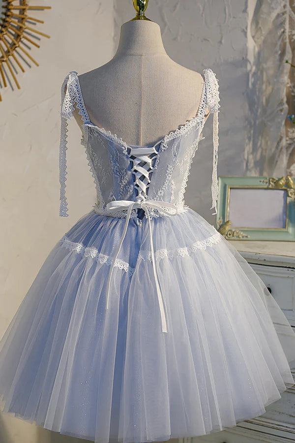 Close-up of the V-neck lace bodice and tulle skirt of the dress.