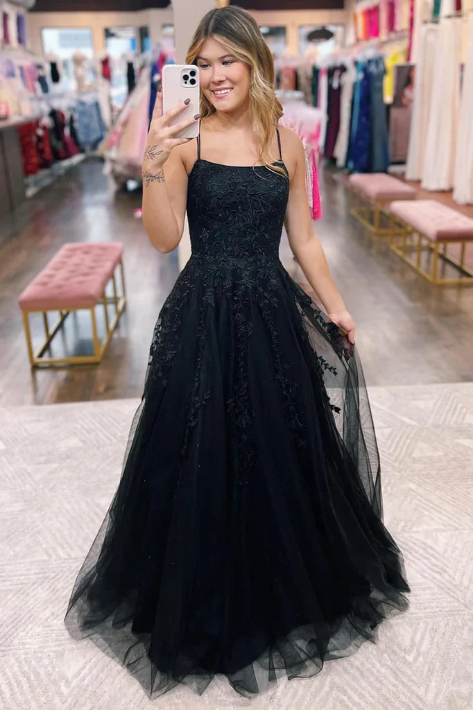 Woman modeling an elegant A-line V-neck tulle lace long prom dress.