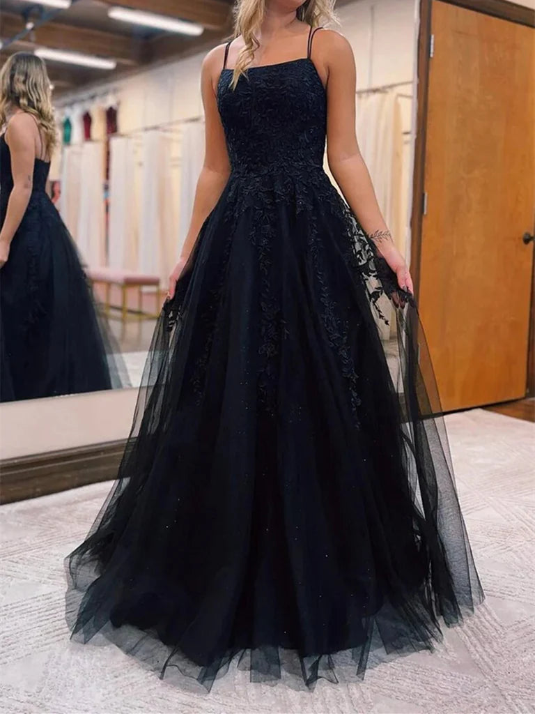 Side view of a woman wearing an A-line V-neck tulle lace long prom dress.