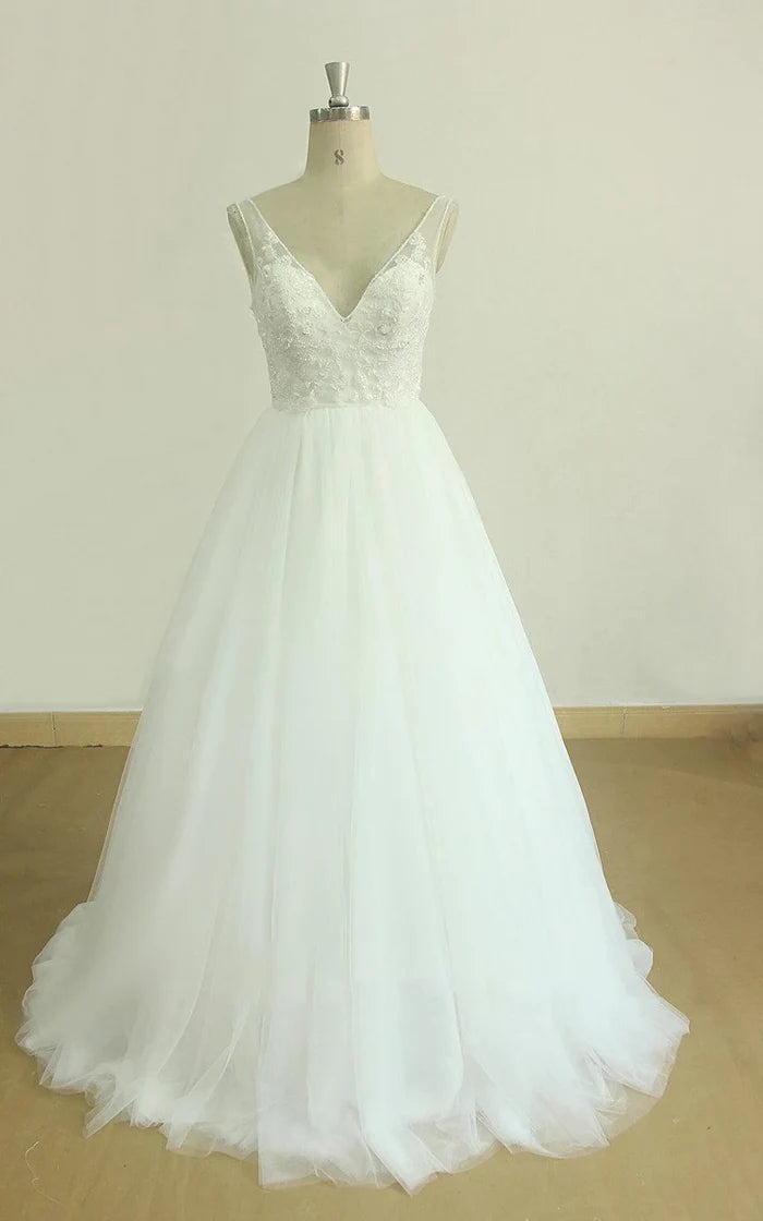 Elegant A-Line V-Neck wedding dress with a flowing tulle and lace train.