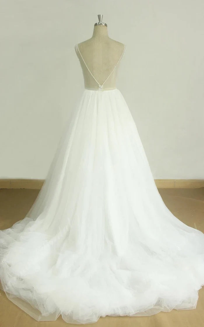 Close-up of the intricate lace and satin details on the V-neck bridal gown.
