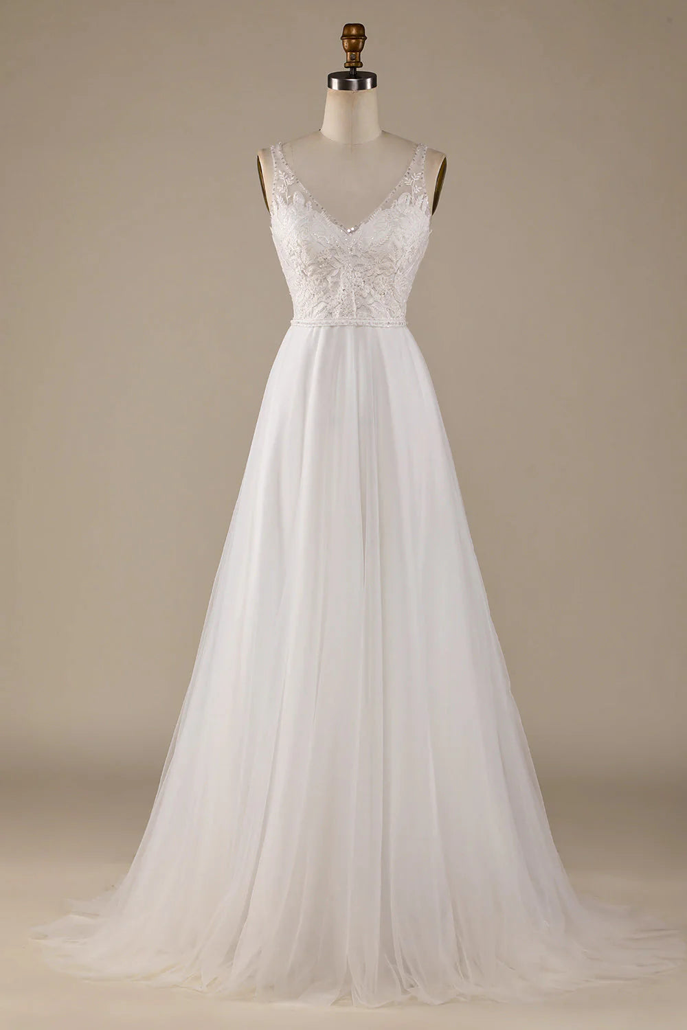 Model wearing an elegant ivory V-neck A-line wedding dress with lace details and a sweep train.