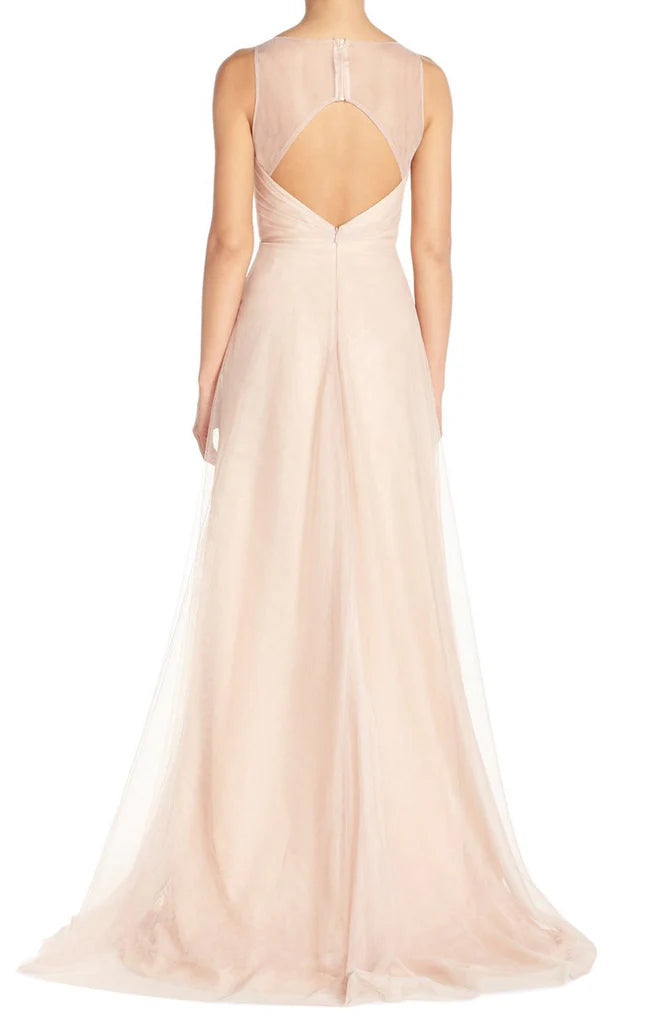 Woman wearing a long A-line V-neck tulle bridesmaid dress.