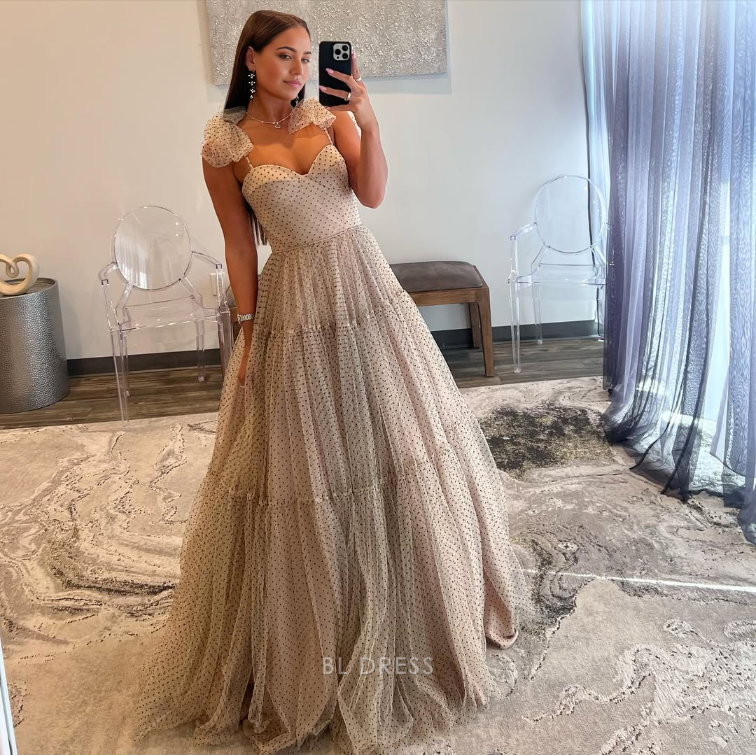 Light blue A-line tulle formal dress with spaghetti straps.