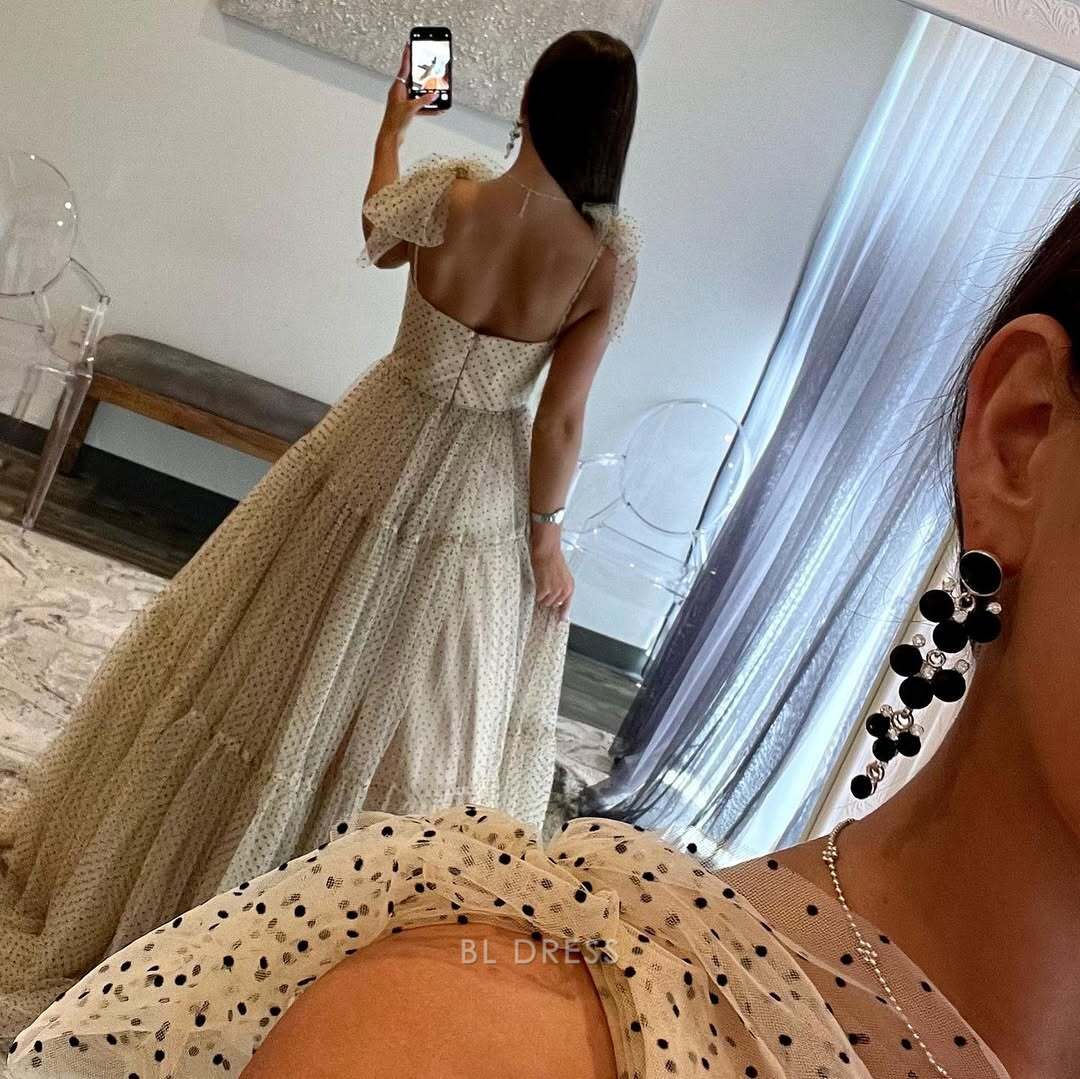 Back view of a light blue A-line tulle bridesmaid dress.
