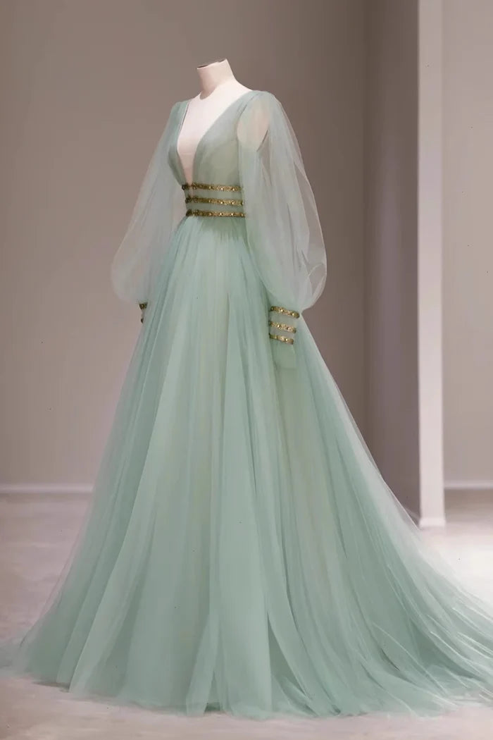 Model wearing an elegant mint green A-line V-neck tulle prom dress.
