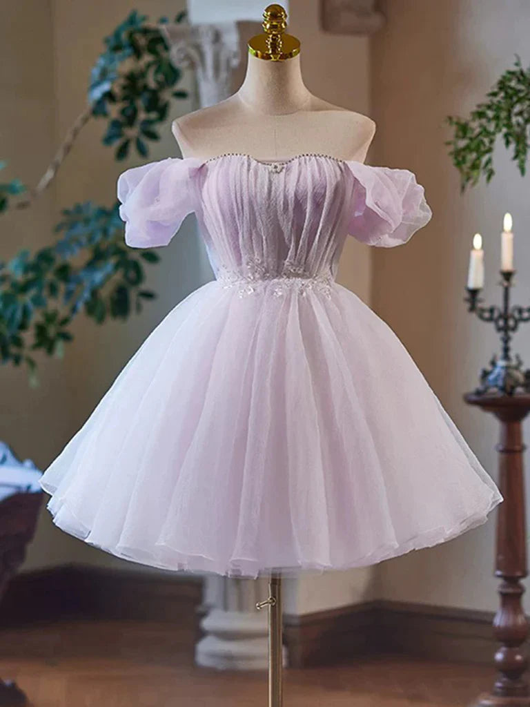 Model wearing a short A-line tulle V-neck dress, suitable for prom or homecoming.