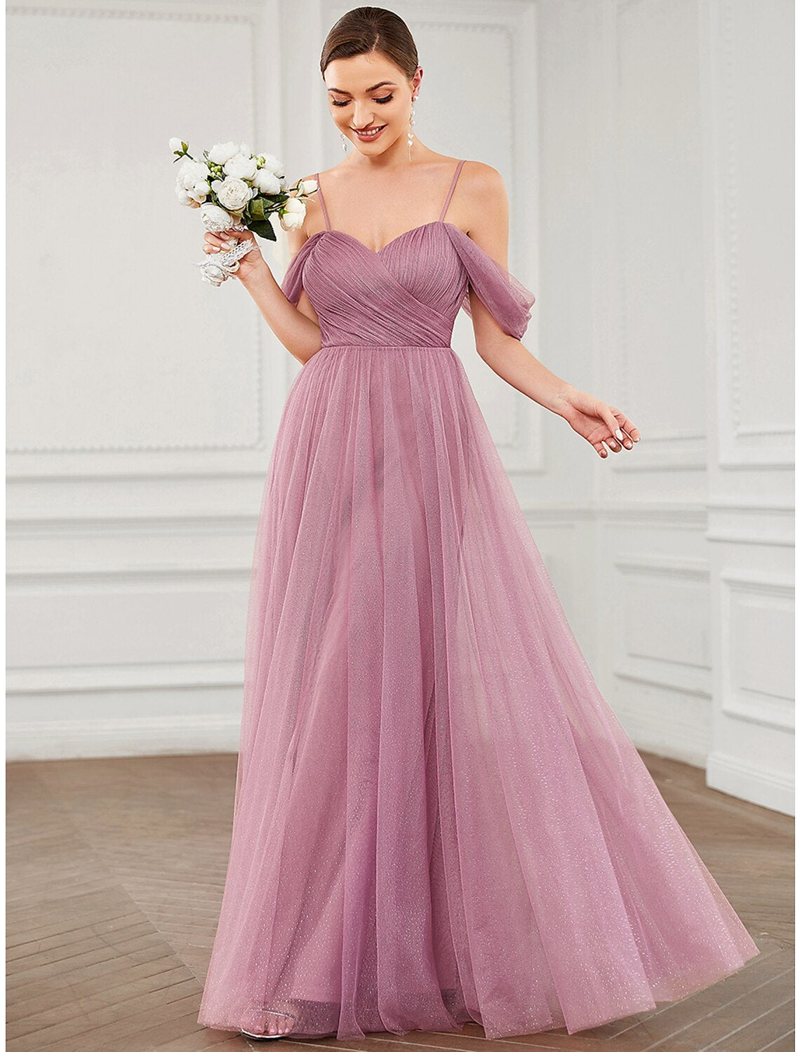 Back view of the floor-length sleeveless tulle gown.