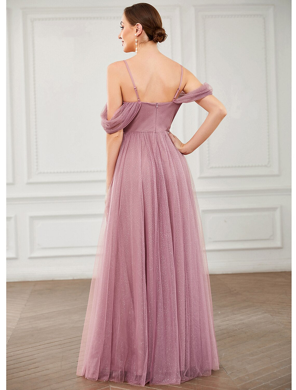 Model posing in the sleeveless floor-length wedding guest dress.