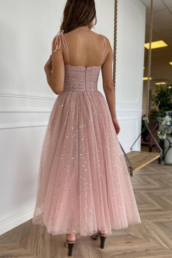 Back view of pink tea length homecoming dress with delicate tulle straps.