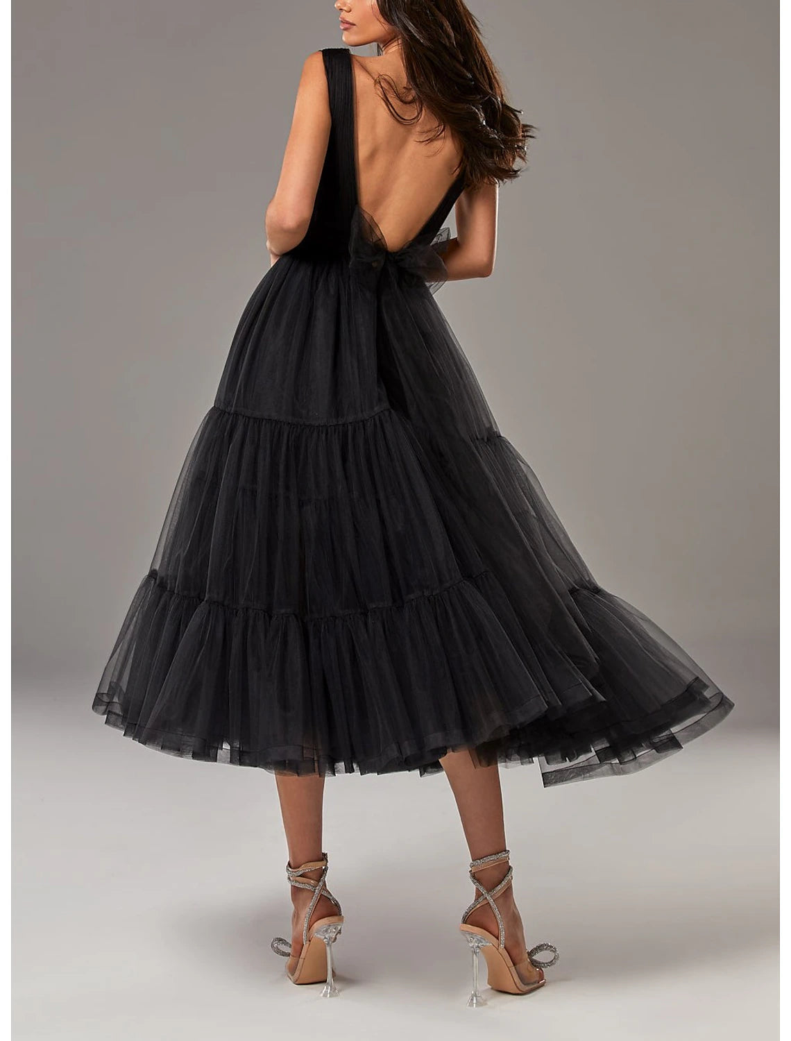 Close-up of the V-neckline and pleated bodice of the tulle dress.
