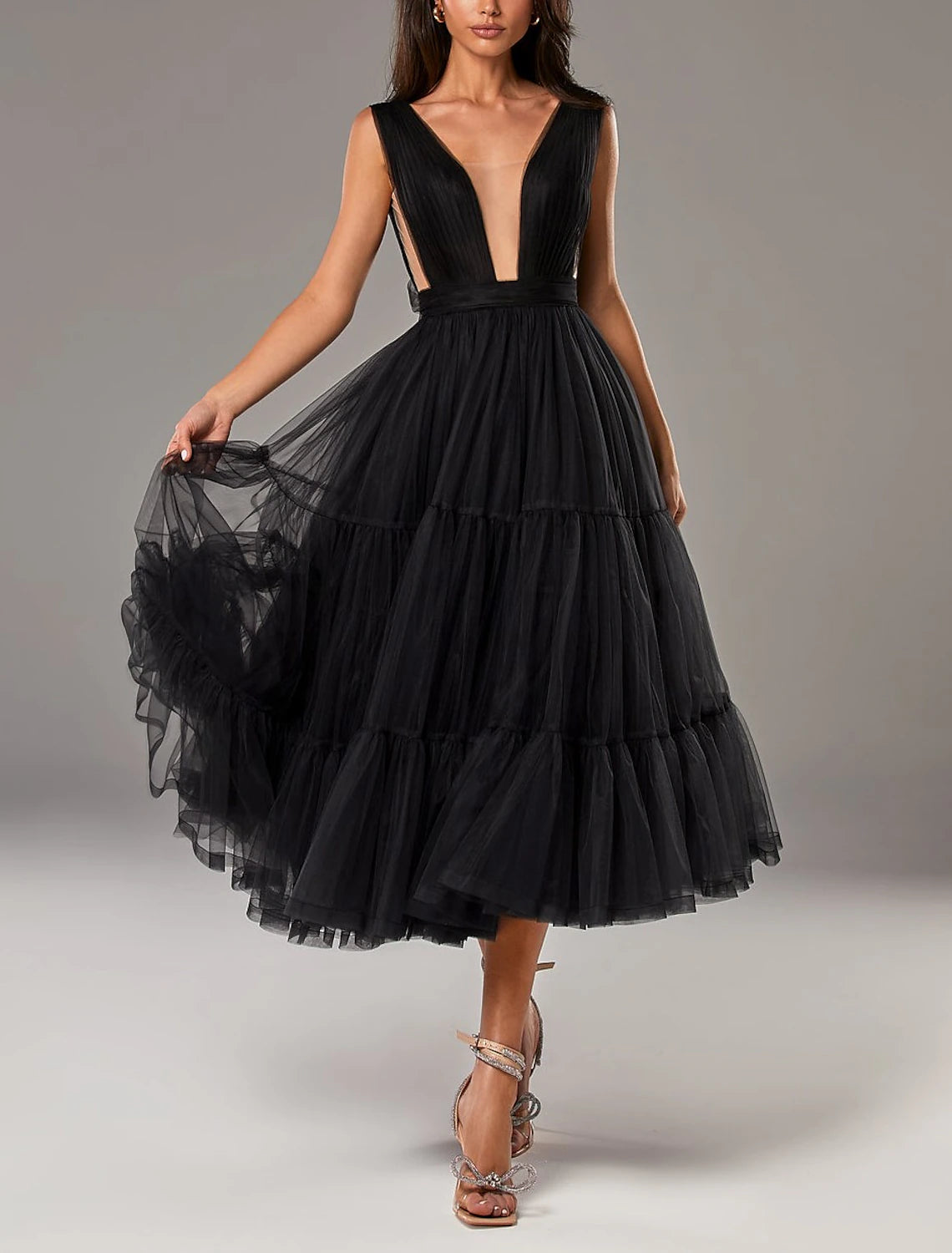 Detail of the bow embellishment on the A-line tea length dress.
