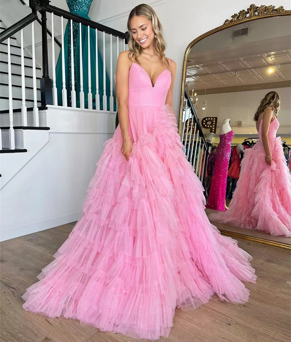 Elegant A-line tulle prom dress with spaghetti straps and tiered skirt.