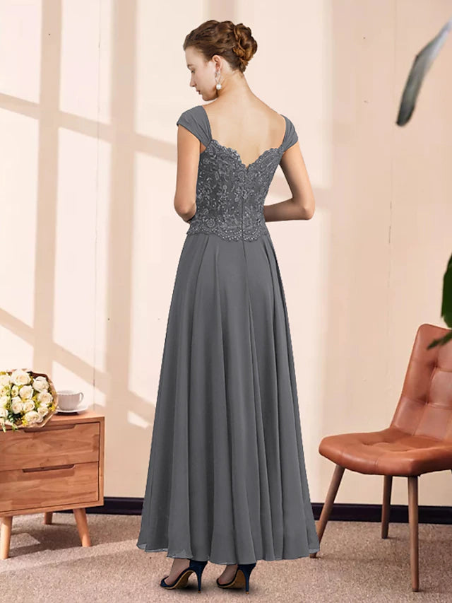 Close-up of the lace appliques and pleated details on the elegant dress.