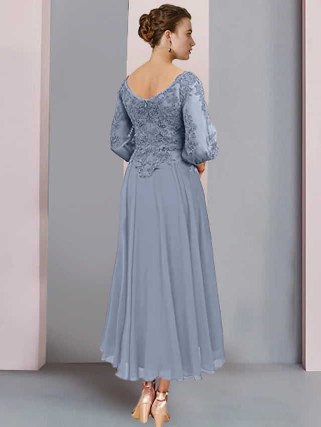 Back view of the elegant tea length A-line dress, showing pleats and appliques.