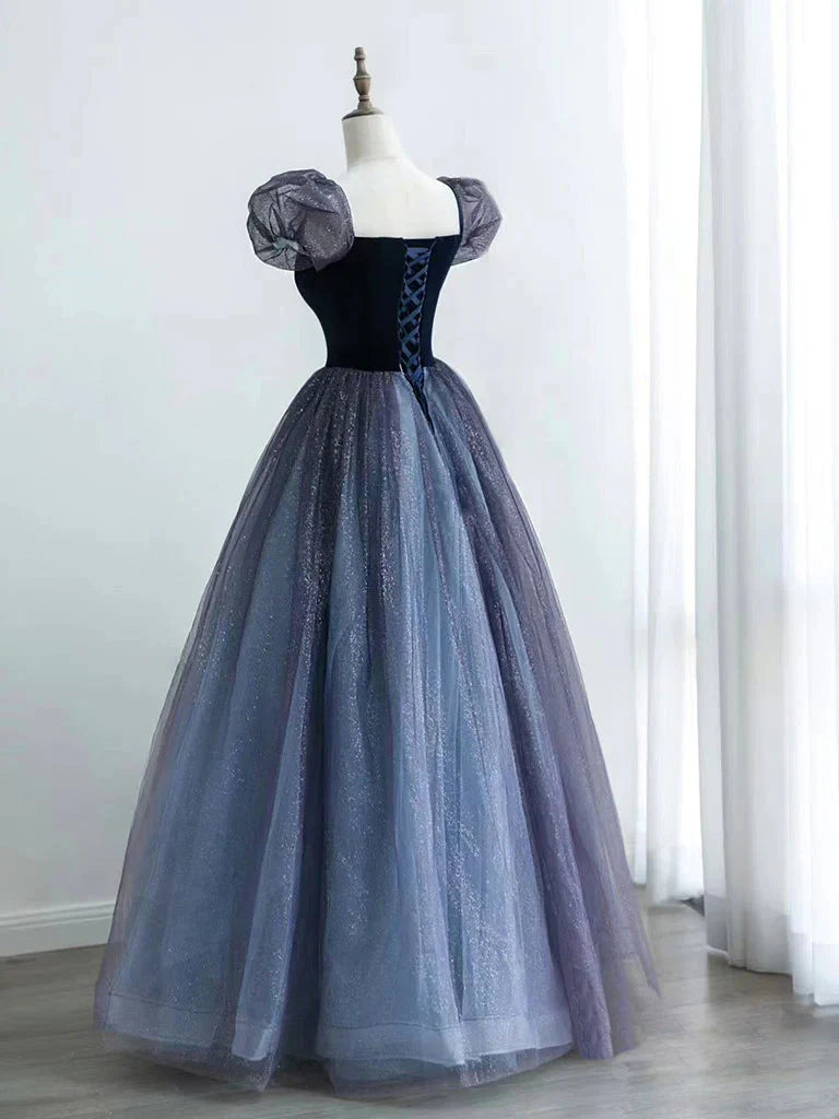 Side view of an A-line V-neck velvet and tulle long prom dress.