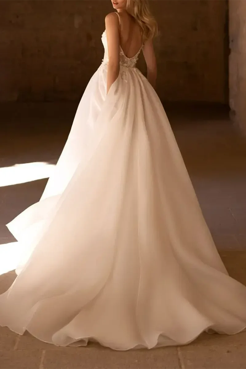 Side view of an A-line V-neck wedding dress adorned with delicate 3D appliques.