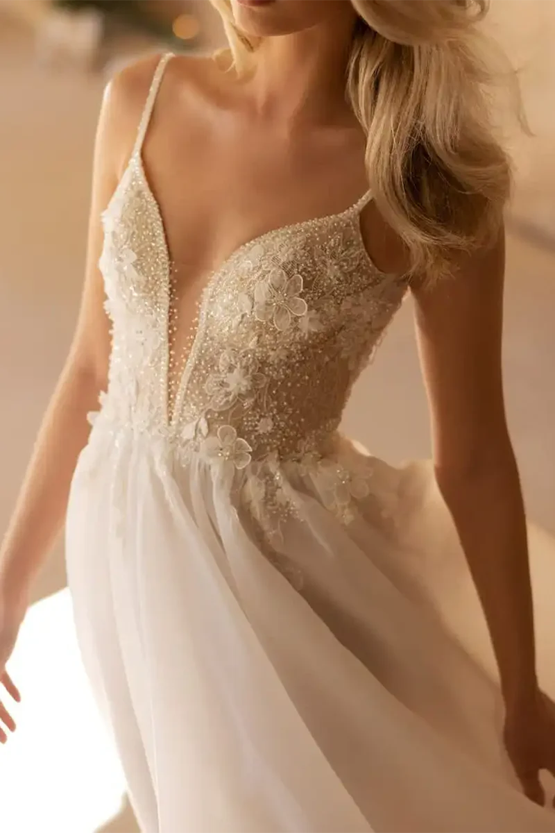 Close-up of the 3D appliques on an A-line V-neck wedding dress.