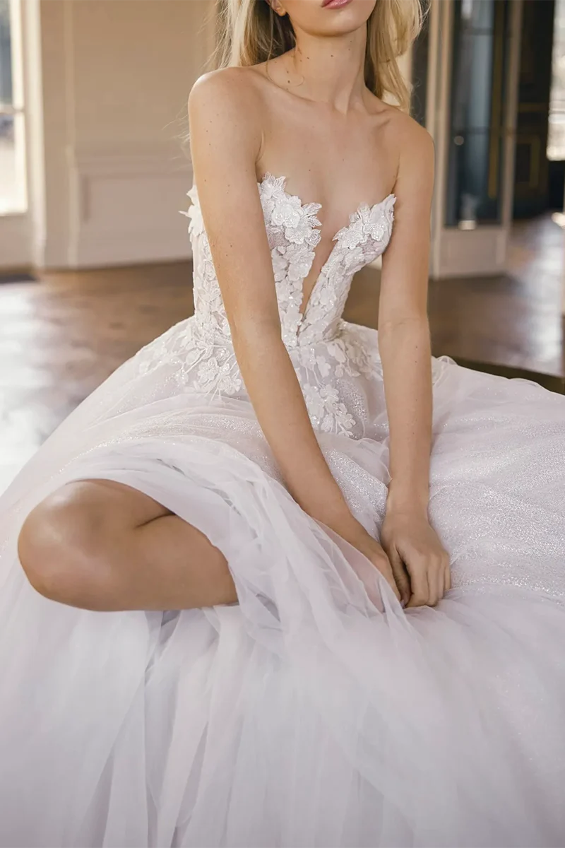 Close-up of 3D appliques on the V-neck wedding dress bodice.