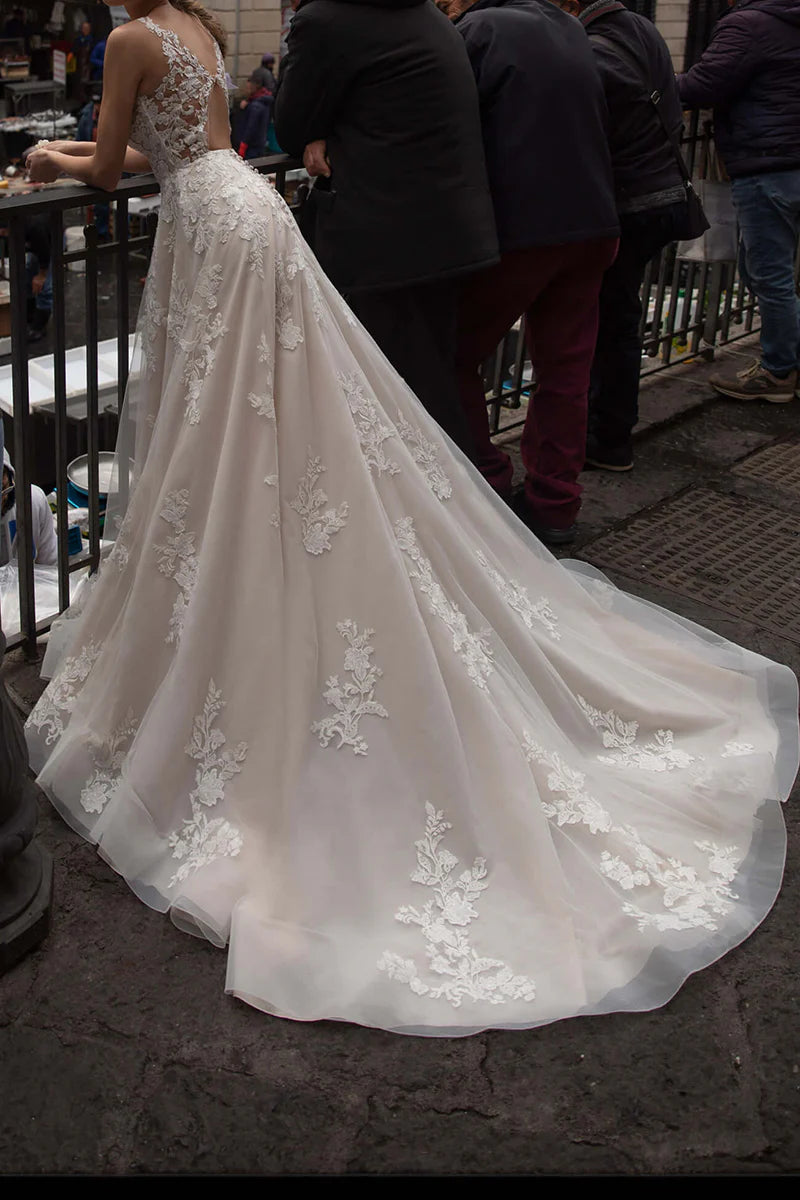 Close-up of intricate lace appliques on the V-neckline of the wedding gown.