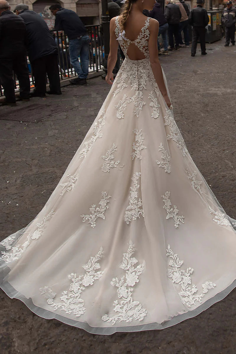 Back view of the bridal gown, highlighting the V-neck and lace details.