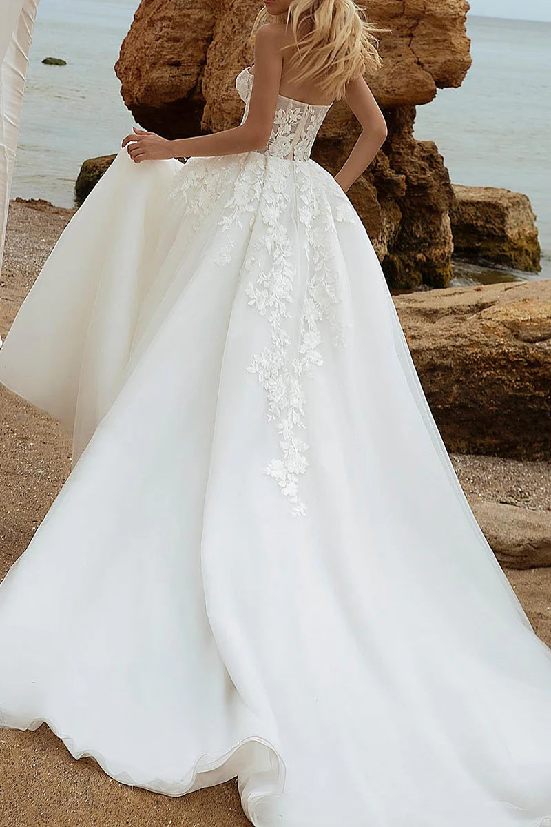 Elegant A-line bridal gown with V-neck and long lace sleeves, side view.