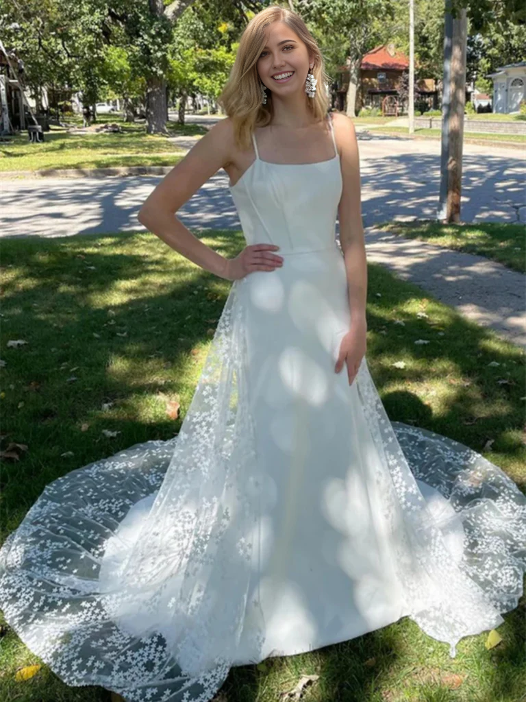 Elegant white lace A-line wedding dress with a V-neckline and long train.
