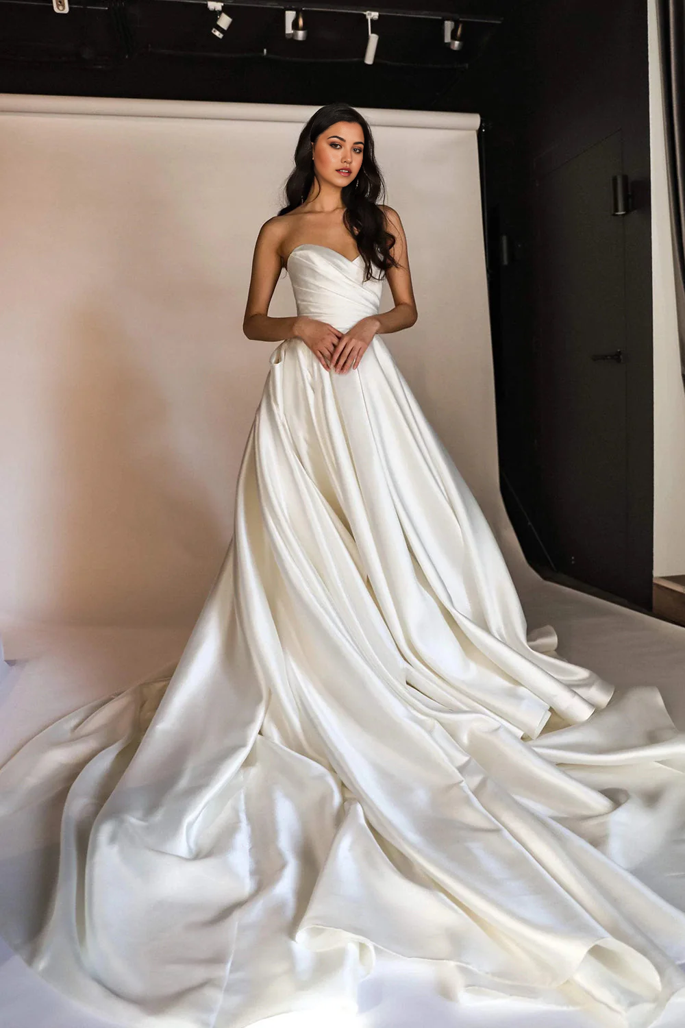 Full view of an elegant A-line V-neck wedding dress with a long sweep train.