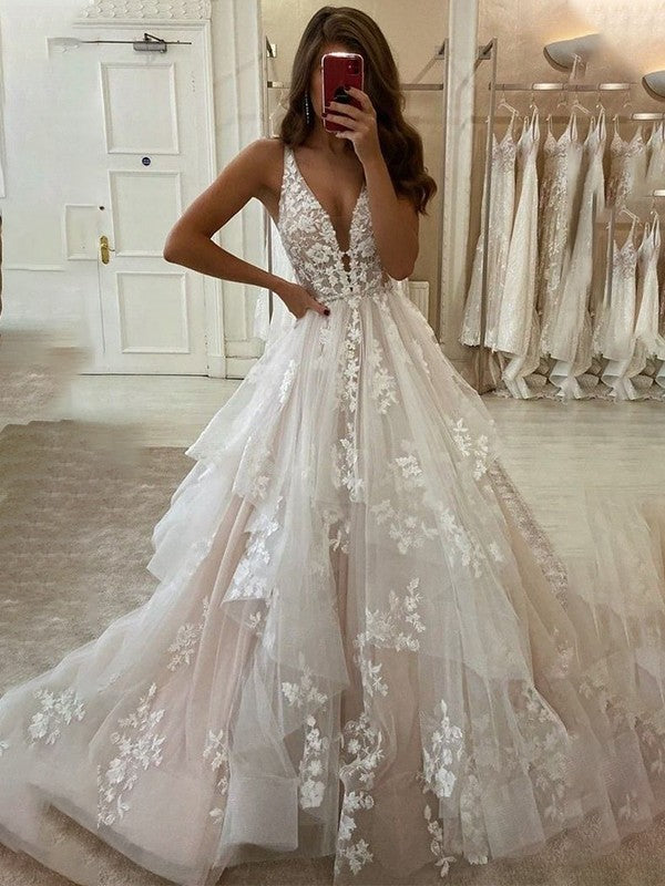 Elegant A-Line wedding dress with V-neck, sleeveless design, and delicate applique details, flowing to the floor.