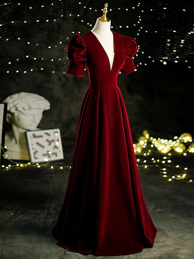 Side view of the velvet A-Line gown, showing pleats and sweep train.