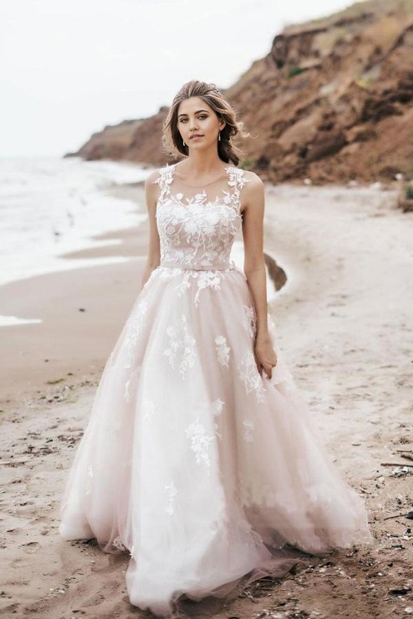 Full view of an A-line vintage lace and tulle wedding dress with a scoop neckline.