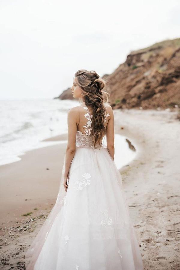 Close-up of the lace bodice and scoop neckline of the wedding dress.