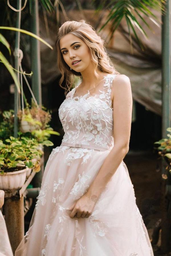 Detailed view of the delicate lace embellishments on the wedding dress.