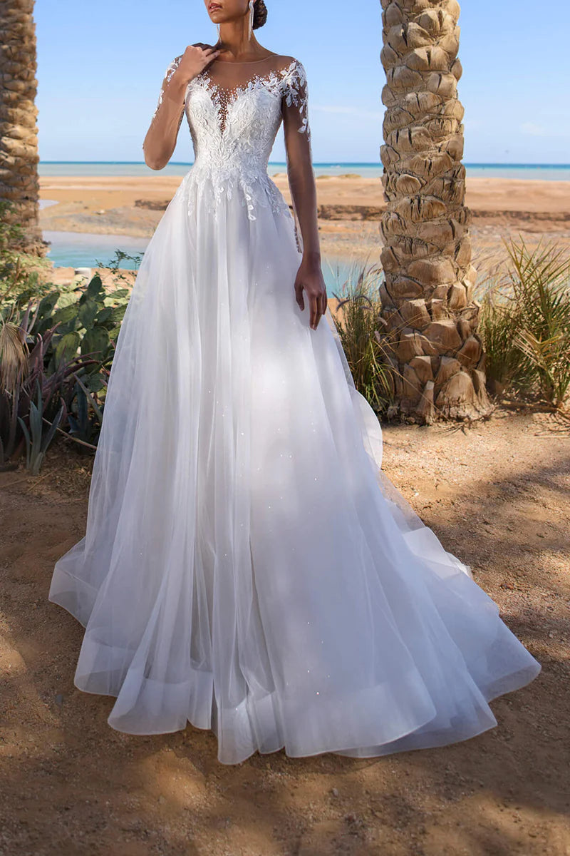 A-Line wedding dress with intricate lace appliques and a low-cut neckline.