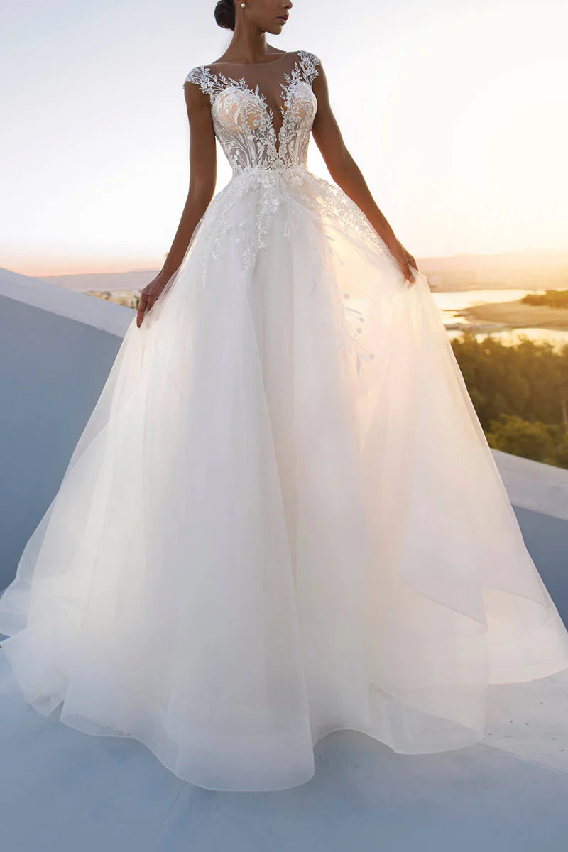 Full view of an elegant A-line wedding dress with a low-cut neckline and intricate lace appliques.
