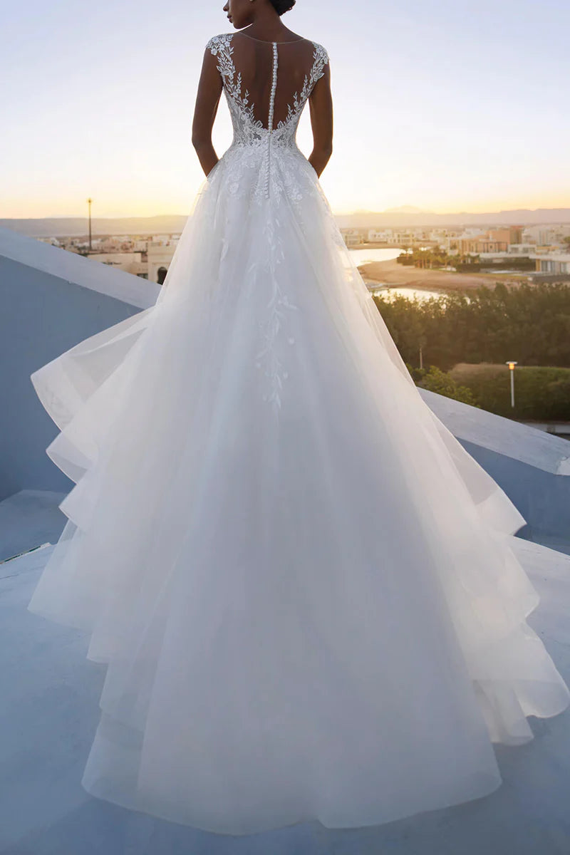 Close-up of the delicate lace appliques and low-cut neckline on the A-line wedding dress.